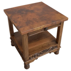 Handcrafted end table with hand-hammered copper top, floral carvings, and bun feet. The DuPont End Table blends Western character with timeless, artisanal craftsmanship.
