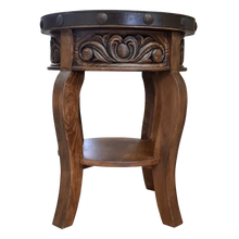 Load image into Gallery viewer, Handcrafted round end table with carved floral base, hammered copper rim, and iron conchos. The Drum End Table blends rustic artistry with refined Western craftsmanship.