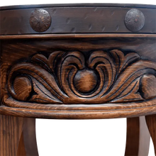 Load image into Gallery viewer, Handcrafted round end table with carved floral base, hammered copper rim, and iron conchos. The Drum End Table blends rustic artistry with refined Western craftsmanship.