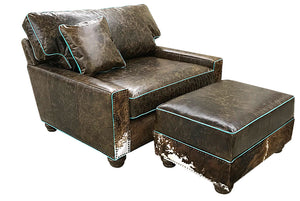 Great Blue Heron's Salado Medium Ottoman 34" x 24" is upholstered using our distressed Buffalo leather and accented with tri color cowhide and turquoise welt. Shown With matching chair and a half