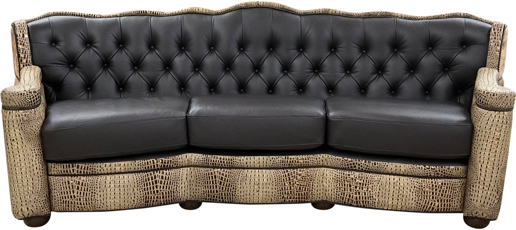 Black leather tufted western cowhide sofa with wicker armrests on a white background