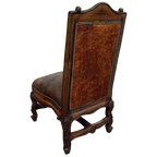 The Matador Dining Chair combines embossed full-grain leather, hand-carved hardwood, and Spanish Colonial artistry. A luxurious Western dining chair handcrafted for beauty, comfort, and endurance. Fully customizable and guaranteed for life.