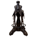 The Mustang Saddle Barstool features embossed turquoise leather, full-grain leather panels, and a hand-forged medallion on a 180° swivel wood base. A handcrafted Western saddle barstool celebrating the artistry and heritage of the American West.