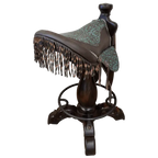 The Mustang Saddle Barstool features embossed turquoise leather, full-grain leather panels, and a hand-forged medallion on a 180° swivel wood base. A handcrafted Western saddle barstool celebrating the artistry and heritage of the American West.