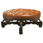 Handcrafted Western ottoman with hand-tooled leather, deep tufting, and carved wood base. The Dominante Ottoman blends rustic elegance with timeless craftsmanship. Customizable.