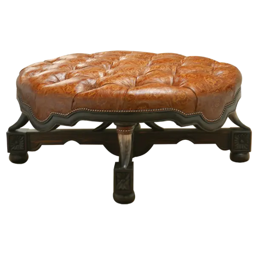 Handcrafted Western ottoman with hand-tooled leather, deep tufting, and carved wood base. The Dominante Ottoman blends rustic elegance with timeless craftsmanship. Customizable.