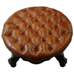 Handcrafted Western ottoman with hand-tooled leather, deep tufting, and carved wood base. The Dominante Ottoman blends rustic elegance with timeless craftsmanship. Customizable.
