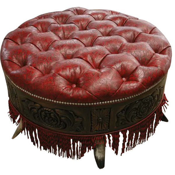 Handcrafted red leather ottoman with carved wood base, nailhead trim, and fringe detailing. The Coronado Ottoman blends Western luxury with timeless artisan craftsmanship.