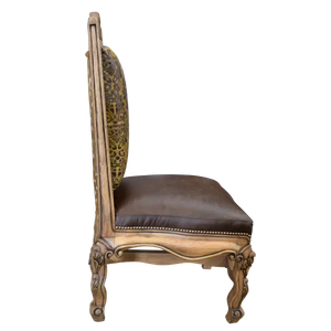 The Picador Dining Chair features full-grain leather upholstery, embossed floral detailing, and hand-carved hardwood. A Spanish Colonial-inspired dining chair blending Western luxury with artisanal craftsmanship. 100% customizable and guaranteed for life.