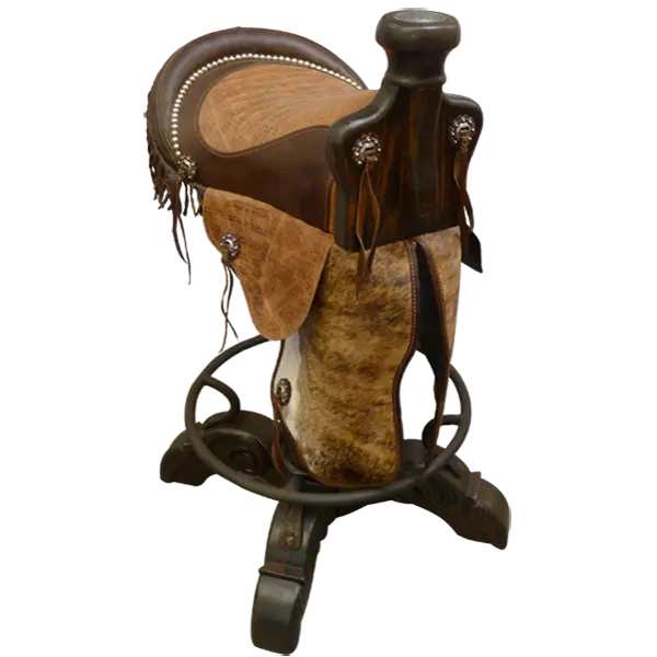 The Saddle Barstool features a handcrafted genuine leather cowboy saddle seat with cowhide fenders, hand-forged conchos, and a turned wood base with iron footrest. A 180° swivel Western barstool blending craftsmanship, comfort, and heritage.