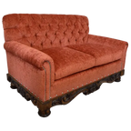 Handcrafted Western loveseat with carved wood base, rust-toned fabric, and tufted backrest. The Durango Loveseat blends rustic warmth with refined craftsmanship. Customizable.