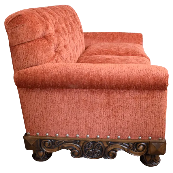 Handcrafted Western loveseat with carved wood base, rust-toned fabric, and tufted backrest. The Durango Loveseat blends rustic warmth with refined craftsmanship. Customizable.