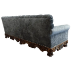 Handcrafted Western-style sofa with deep tufting, carved wood base, and customizable upholstery. The Hidalgo Sofa blends rustic elegance with heirloom craftsmanship.
