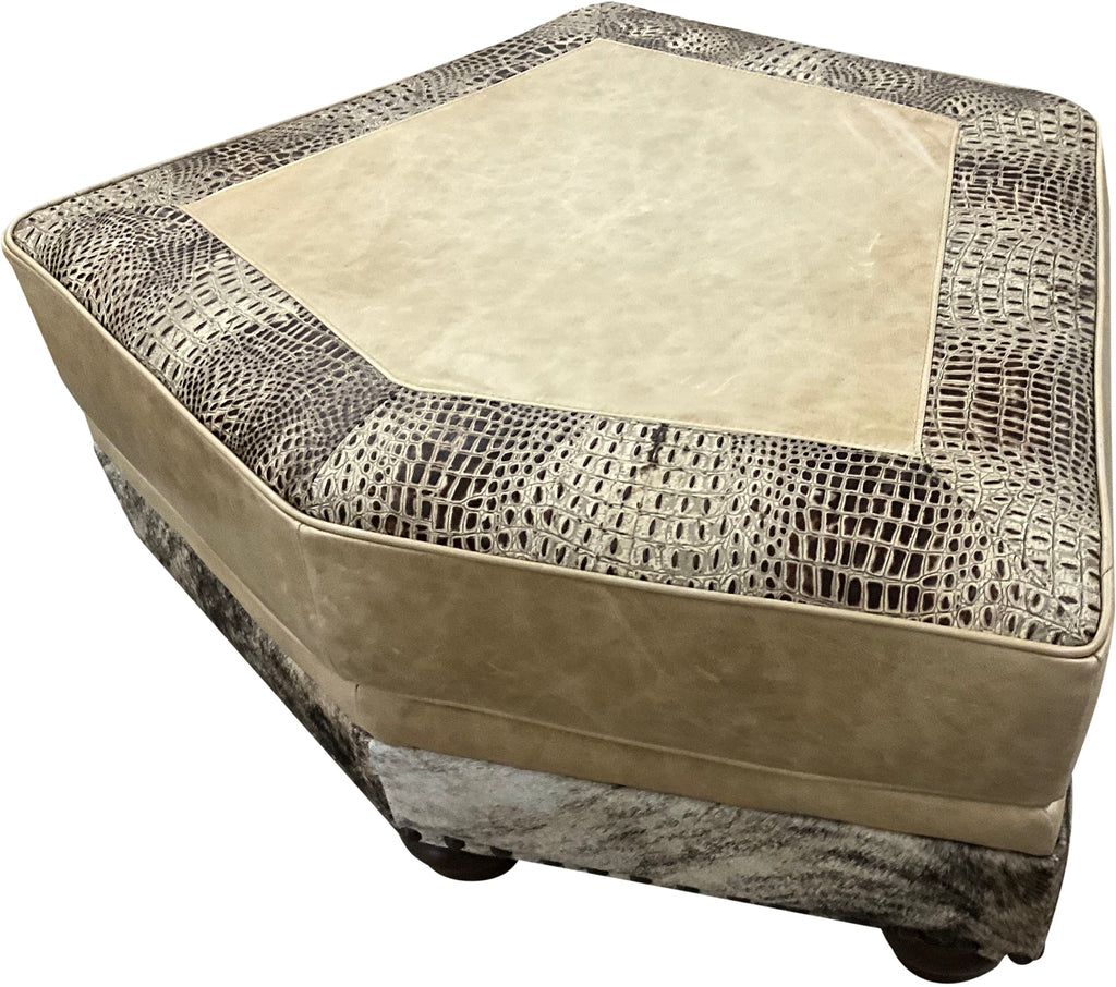 Hexagonal ottoman with textured beige top and patterned base on a white background, called palomino theater ottoman