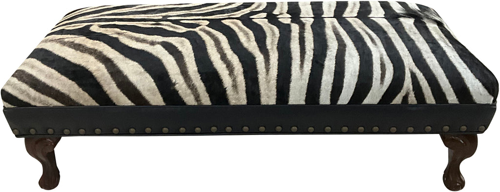 Luxury zebra hide bench with authentic zebra hide seat, Fendi Night leather rail, nailhead trim, and traditional ball-and-claw wood frame. Exotic statement bench 60".
