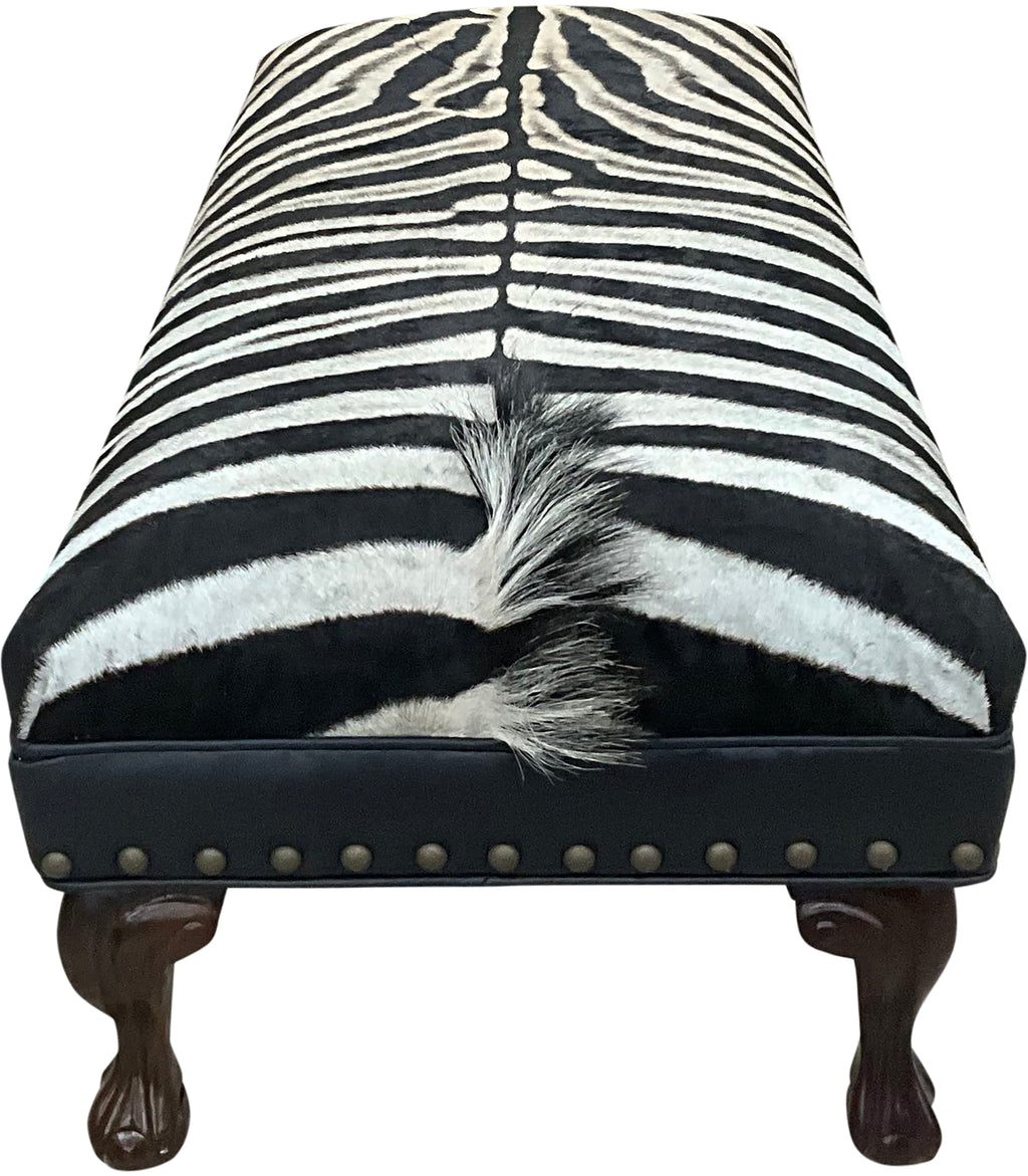 Luxury zebra hide bench with authentic zebra hide seat, Fendi Night leather rail, nailhead trim, and traditional ball-and-claw wood frame. Exotic statement bench 60".