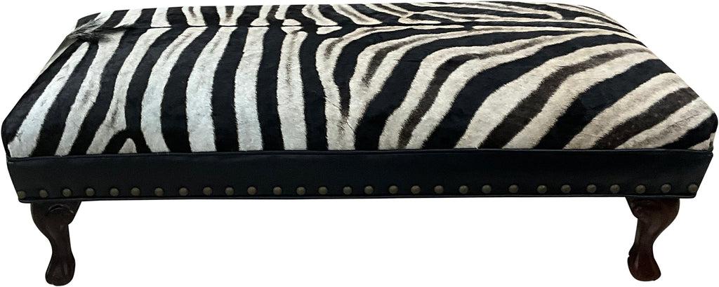 Luxury zebra hide bench with authentic zebra hide seat, Fendi Night leather rail, nailhead trim, and traditional ball-and-claw wood frame. Exotic statement bench 60".