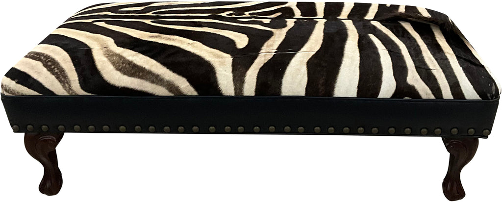 Luxury zebra hide bench with authentic zebra hide seat, Fendi Night leather rail, nailhead trim, and traditional ball-and-claw wood frame. Exotic statement bench 60".