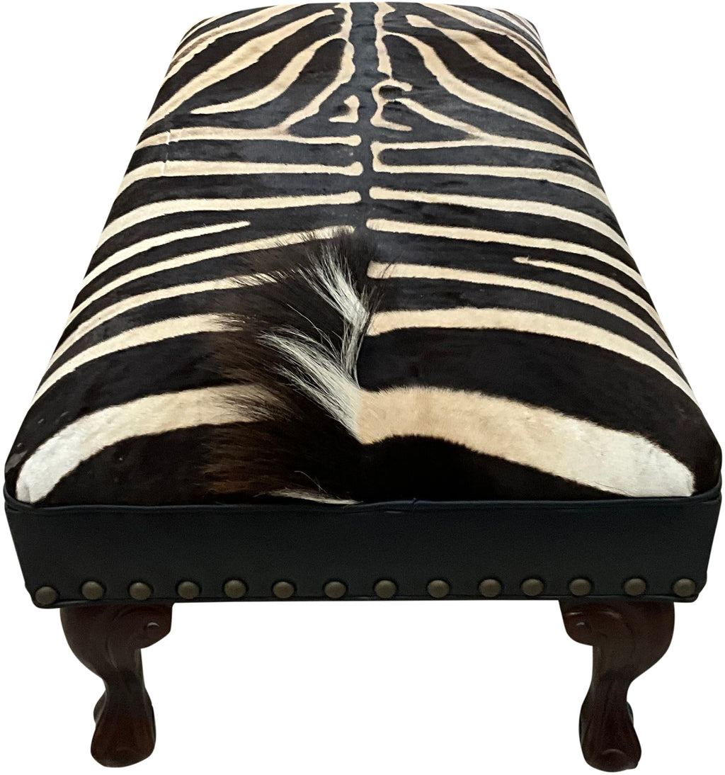 Luxury zebra hide bench with authentic zebra hide seat, Fendi Night leather rail, nailhead trim, and traditional ball-and-claw wood frame. Exotic statement bench 60".