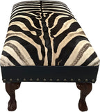 Luxury zebra hide bench with authentic zebra hide seat, Fendi Night leather rail, nailhead trim, and traditional ball-and-claw wood frame. Exotic statement bench 60".