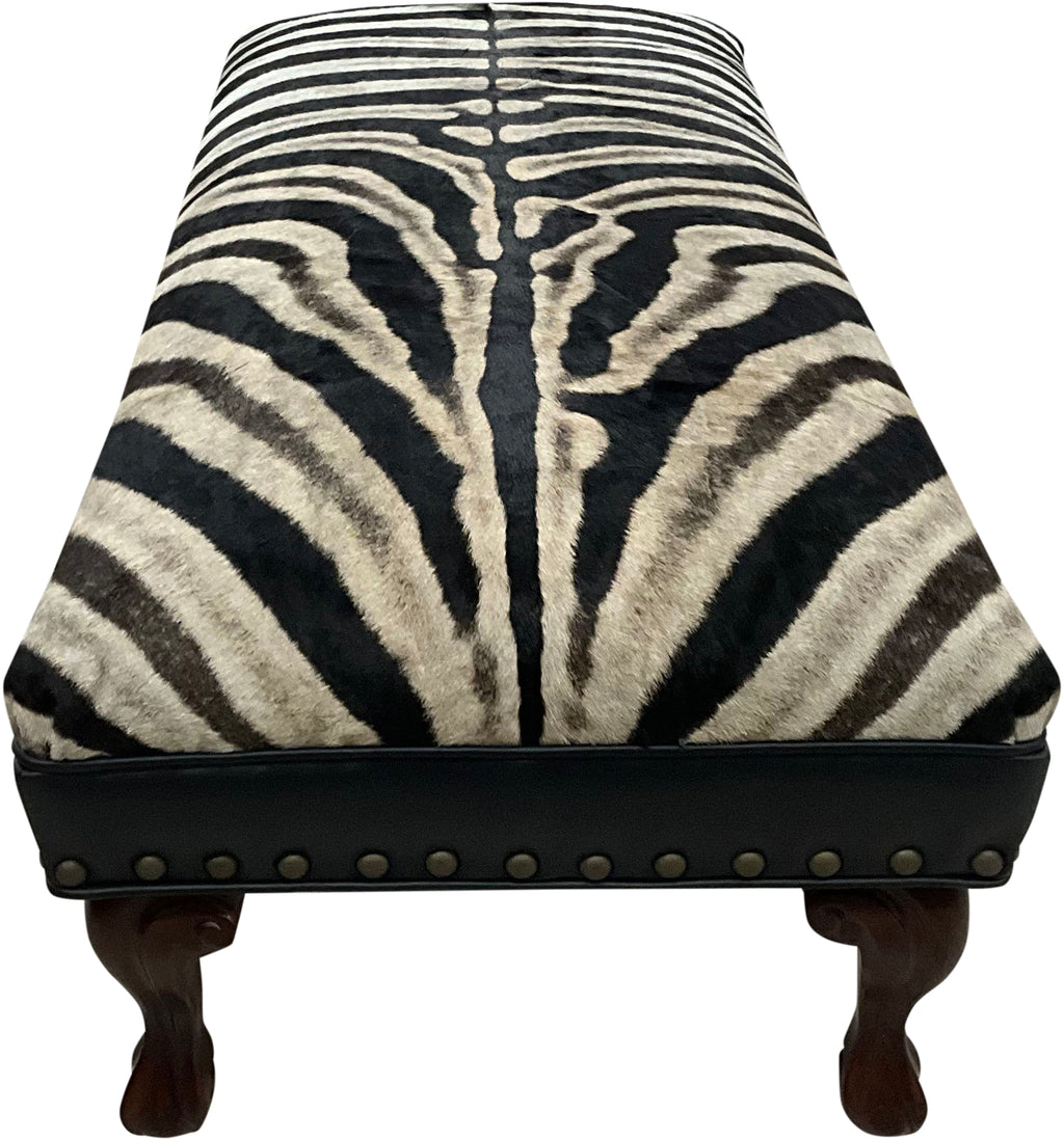 Luxury zebra hide bench with authentic zebra hide seat, Fendi Night leather rail, nailhead trim, and traditional ball-and-claw wood frame. Exotic statement bench 60".