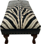 Luxury zebra hide bench with authentic zebra hide seat, Fendi Night leather rail, nailhead trim, and traditional ball-and-claw wood frame. Exotic statement bench 60".