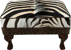 Luxury zebra hide ottoman with authentic zebra hide and mane top, Gator Walnut leather rail, nailhead trim, and carved wood legs. Western safari accent stool 27" x 17".
