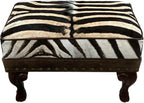 Luxury zebra hide ottoman with authentic zebra hide and mane top, Gator Walnut leather rail, nailhead trim, and carved wood legs. Western safari accent stool 27" x 17".