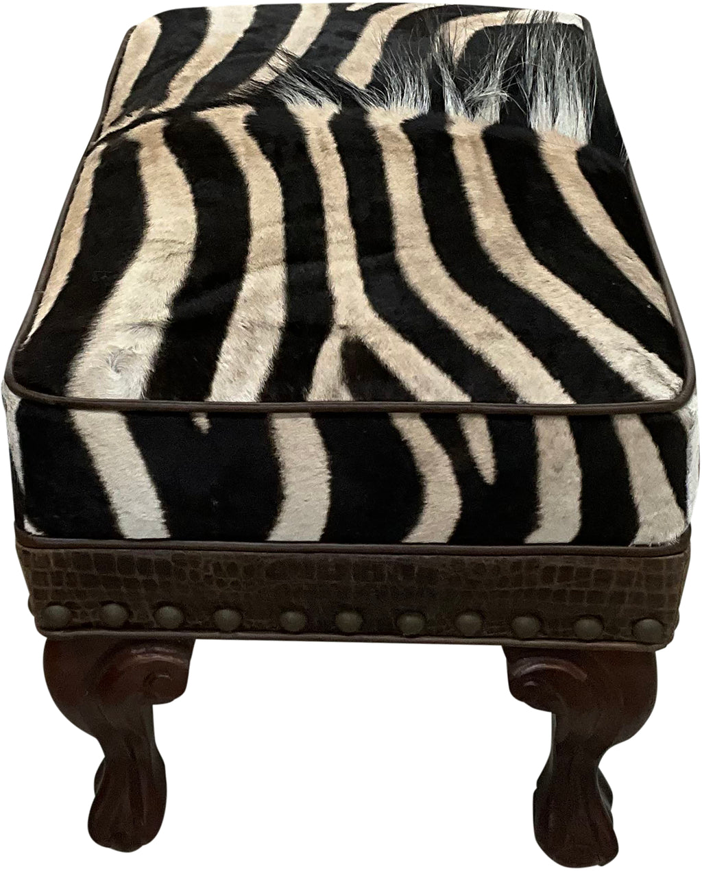 Luxury zebra hide ottoman with authentic zebra hide and mane top, Gator Walnut leather rail, nailhead trim, and carved wood legs. Western safari accent stool 27" x 17".
