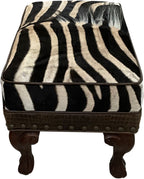 Luxury zebra hide ottoman with authentic zebra hide and mane top, Gator Walnut leather rail, nailhead trim, and carved wood legs. Western safari accent stool 27" x 17".